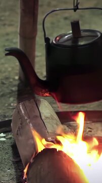Vintage Metal Kettle Boiling Over Open Campfire Close Up - 4K Vertical