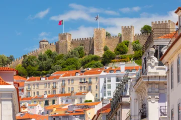 View of Sao Jorge Fortress rising above the historic Alfama district in Lisbon, Portugal. © Kavalenkava
