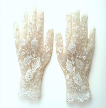 pair of delicate ivory lace gloves with floral embroidery laid flat on a white background, evoking romantic vintage elegance