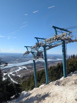 Skiing in winter - chairlift gondola and ski slopes for skiing and snowboarding  between trees on frosty day with beautiful views in  mountains