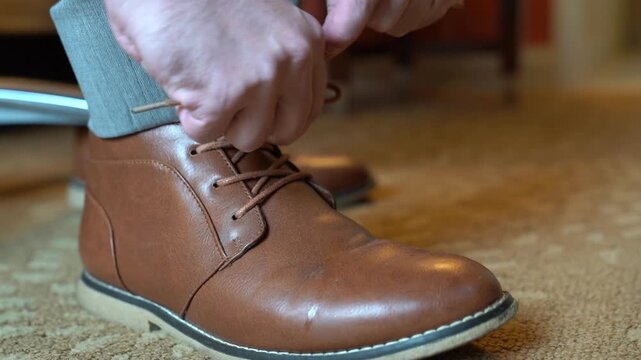 Close-Up of Groom Tying Brown Leather Shoe