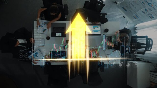 Aerial view of a business meeting focused on financial data analysis. Professionals engage with charts and graphs, driving strategic decisions for growth in a dynamic office setting. Raster