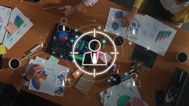 A diverse team engages in a collaborative business meeting, analyzing data graphs and charts in a modern office. A target icon overlay highlights focus areas for growth. Raster