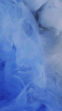 Vertical video. Steam swirling ink. Vapor background. Blur blue neon color paint in liquid water chemical fluid spreading on art dark black abstraction.