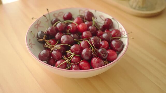 Cherries in a bowl on a wooden table