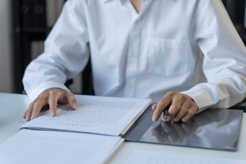 Fototapeta premium Lawyer sits on chair and reading documents, Justice process concept
