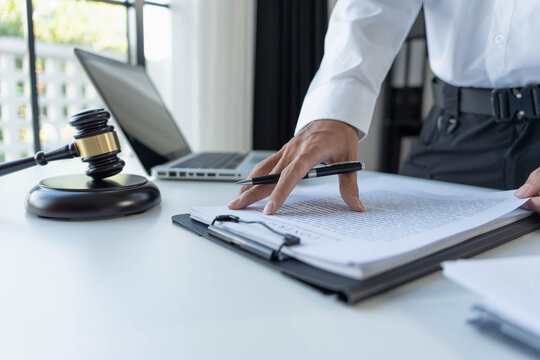 Lawyer standing checking documents on laptop