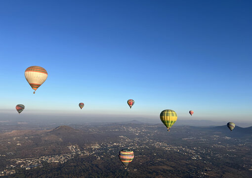 Aerial view of hot air balloons floating over the ancient Pyramids of Teotihuacan landscape at sunrise in Mexico City, Mexico City, Mexico.