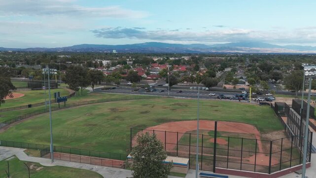 Wide panning aerial shot of a high school baseball field in Southern California. 4K