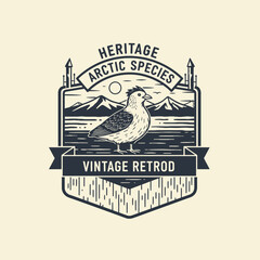 Heritage arctic species vintage puffin bird mountain logo. © BasthaDocumentary