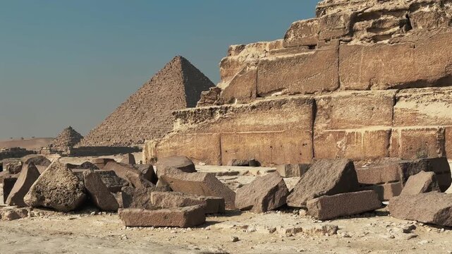 Close Up of the huge stone blocks of the Pyramid of Khafre base and Pyramid of Menkaure in the Background at Giza Necropolis
