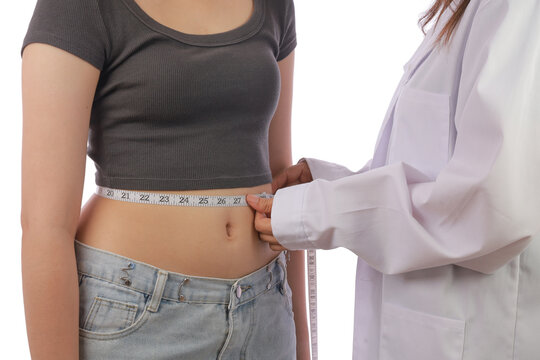 Medical professional measuring waist for weight management before injection treatment in clinic setting