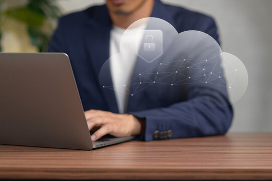 Business Professional Using Laptop with Cloud Technology Visualization in Office Setting