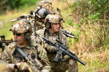 Fototapeta premium Special operations soldiers maintain concealment and observation while conducting reconnaissance