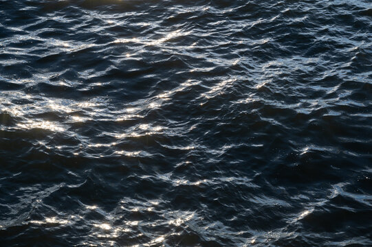 Sun glistening on blue water waves
