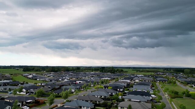 Drone pan over Rangiora, New Zealand, with a dramatic asperitas cloud formation creating a turbulent, wave-like sky over the town.
