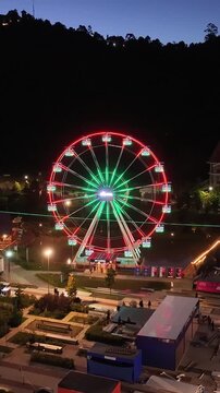 Night View Of Capivari Village In Campos Do Jordao In Sao Paulo Brazil. Illuminated Ferris Wheel. Downtown Cityscape. European Architecture. Capivari Village In Campos Do Jordao In Sao Paulo Brazil. 