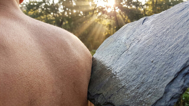 Close up of woman bare back resting on smooth warm slate stone slab outdoor sun meditation