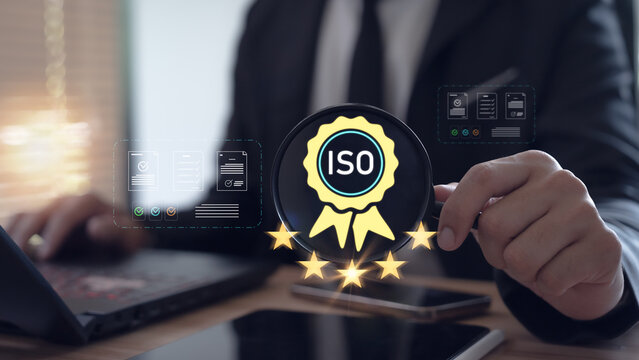 A business professional is reviewing digital ISO certification standards in accordance with 5-star certified quality assurance requirements.