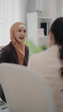 Multiethnic coworkers working together, Asian muslim