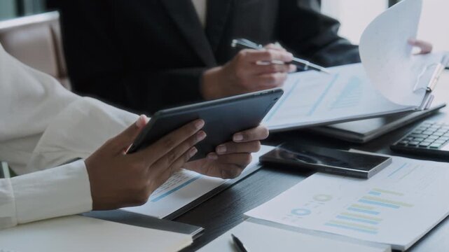 Financier team collaborates on project details in finance meeting session