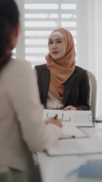 Multiethnic coworkers working together, Asian muslim