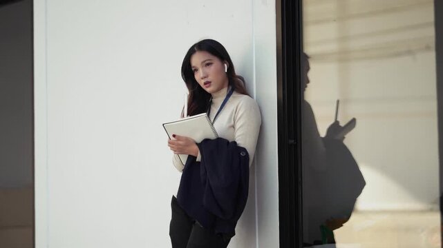 Business woman takes notes on paper notebook outdoors in city