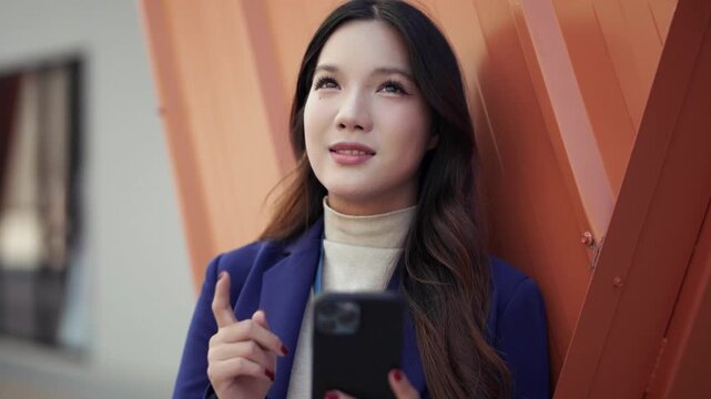 Female standing outdoors using smartphone with enjoyment