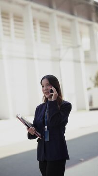 business woman strides along city streets outdoors during her busy workday