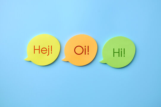Colorful greeting speech bubbles isolated on blue background