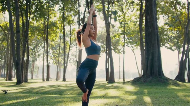 Fitness woman focuses deeply on yoga poses during outdoor training session