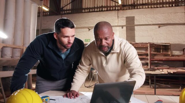 Carpentry, collaboration and laptop with men in warehouse together for management or planning. Computer, discussion and teamwork with people in woodworking plant for agenda, schedule or timetable