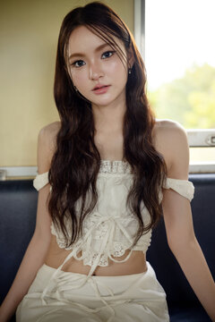 Social media trend in Thailand, Portrait of a stylish young Asian woman on a vintage train. Seated by the window, soft natural light creates a beautiful and timeless aesthetic.