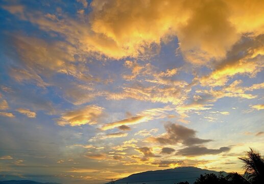 Golden Sunset Clouds with Mountain Silhouette in Tropical Sky, West Java Indonesia