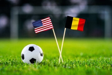 Obraz premium United States vs Belgium, national flags before international football match, football on green grass with stadium in the background, Lumen Field, Seattle, United States, July 6, 2026