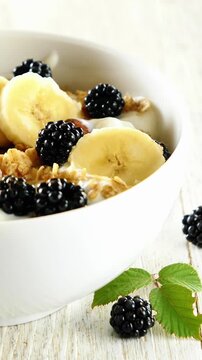 Healthy Breakfast Bowl with Granola Yogurt Sliced Banana and Fresh Blackberries Food Macro
