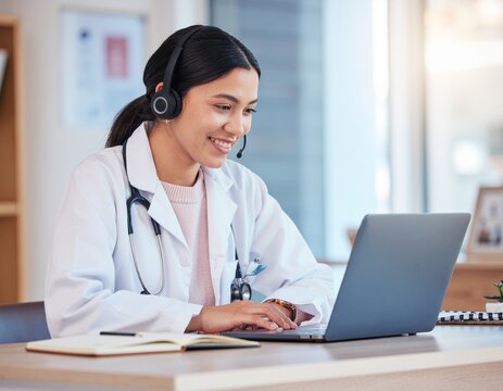 Female doctor using laptop for telemedicine consultation.