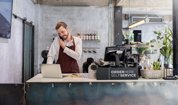 Startup successful small business owner sme caucasian man, handsome boy stand in coffee shop restaurant. Portrait of long hair man barista cafe owner. SME entrepreneur business seller
