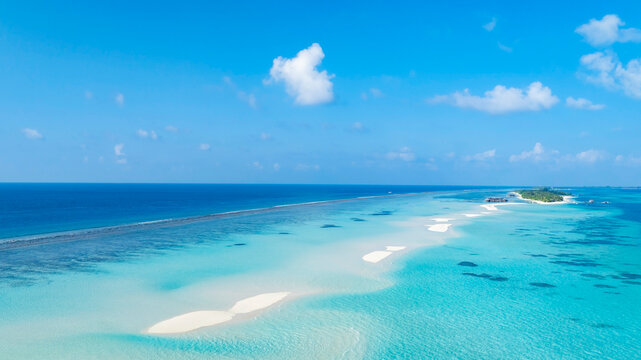 Aerial view of Summer lagoon Ripples in the sand at low tide on a beach with sandbar background and blue sea in Maldives island