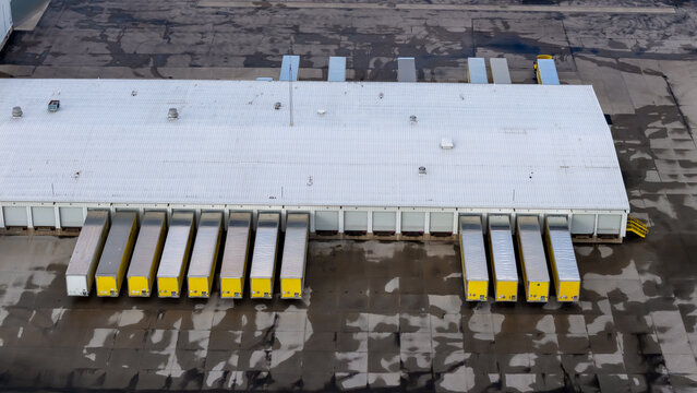 Aerial view trucks waiting at distribution center loading docks