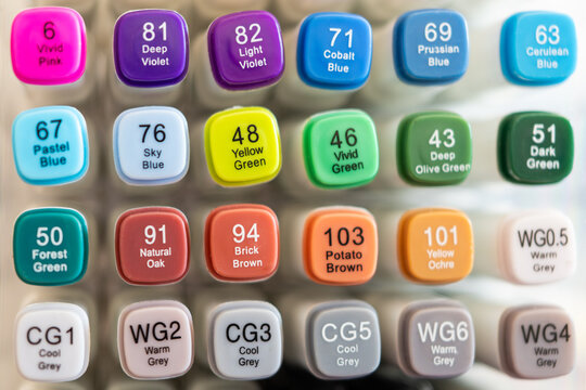 Close up of colorful alcohol markers set. Bright caps with numbers and color names for drawing and art.