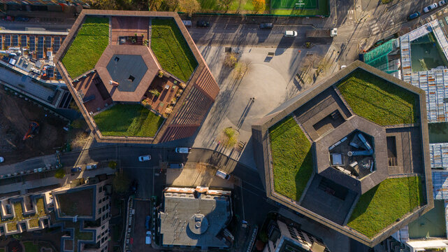 Aerial view of the hexagonal Mono Tower and Duo Tower at Hoxton Press featuring green roofs and modern architecture in London, England, United Kingdom.