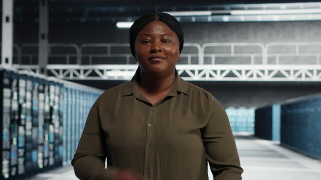 Mesmerized woman explores online media access near a video wall, suggesting streaming videos and social media videos.