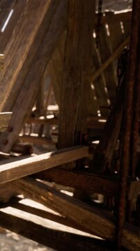 Workers build a wooden structure in a construction area. Sunlight shines through the beams, highlighting the wooden framework. Tools and materials are scattered around the site.