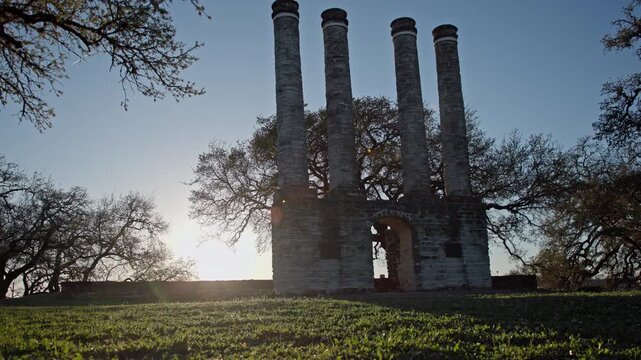 Decaying Victorian Building Remains with tall chimneys and Stone Structures