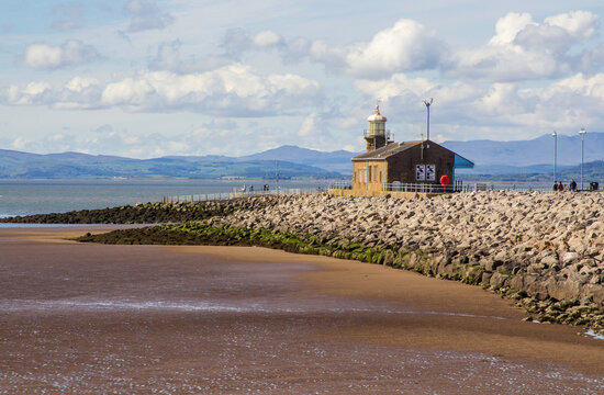 The Stone Jetty Breakwater in Morcambe Bay in the North West of Englandl ooking across the sand and mudflats