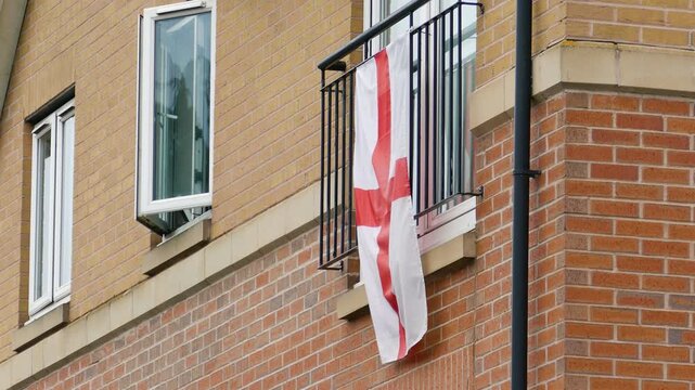 England flags hanging from a residential building in London. A symbol of patriotism and football support