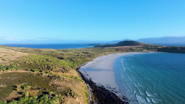 Aerial drone footage of the curving coastline, open bay and rolling landscape of Carcass Island in the Falkland Islands,  remote nature theme.