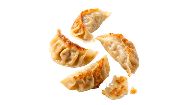 Scattered traditional golden crispy fried asian dumplings potstickers isolated on transparent background