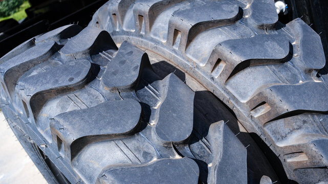 Close-up of a tractor tire on a construction site. Heavy-duty tires.